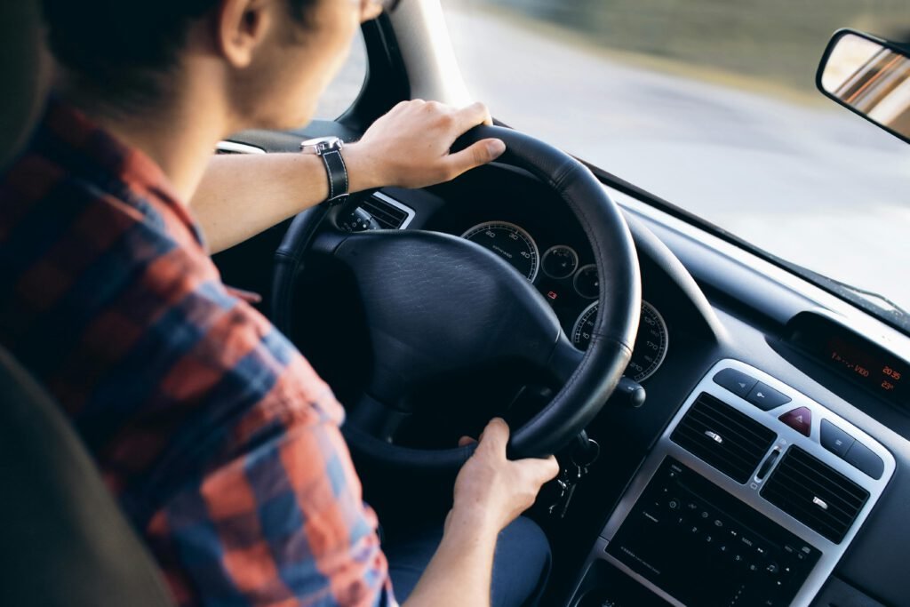 A learner driver concentrating with both hands on the steering wheel