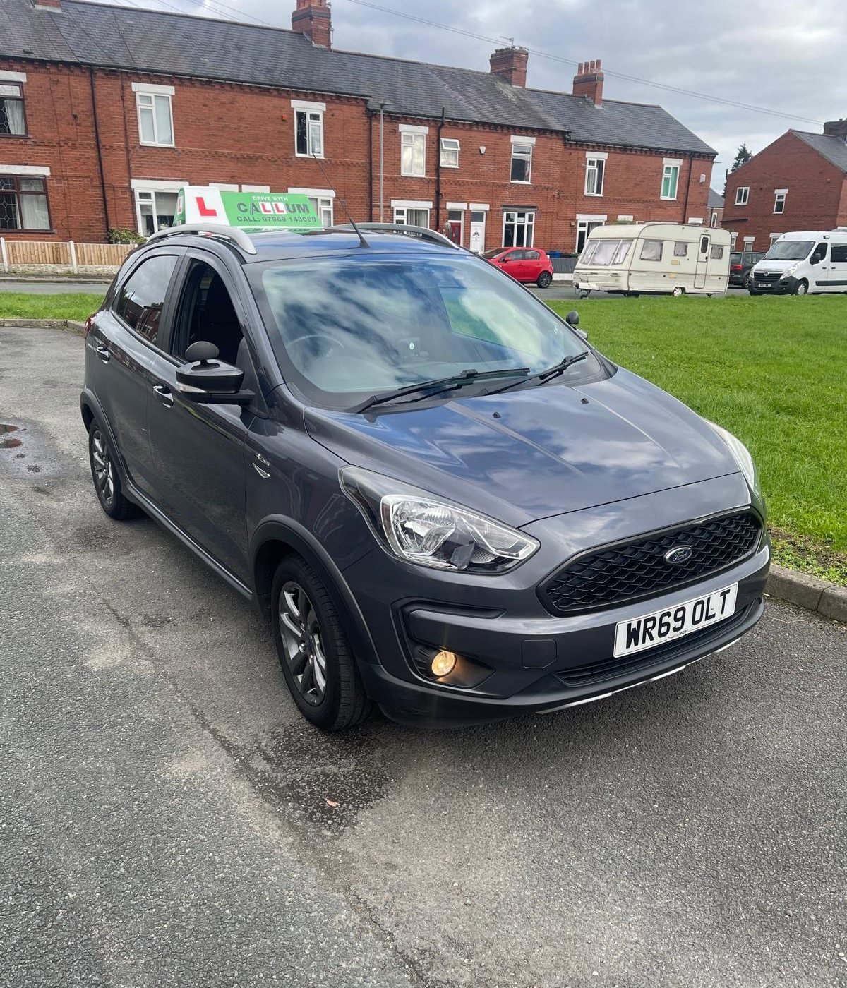Drive With Callum’s grey Ford Ka+ tuition car parked on a residential street in Leigh